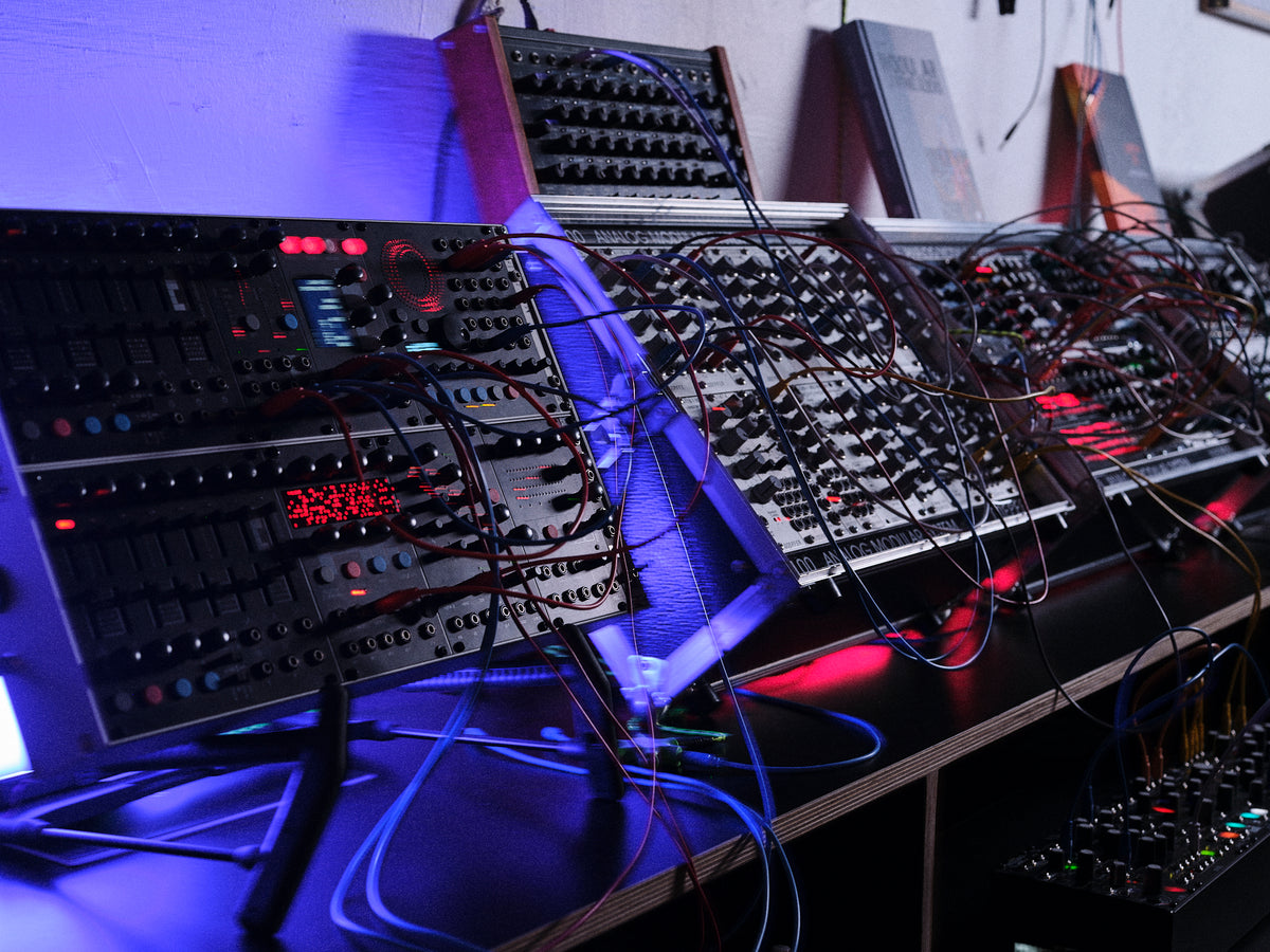 Hands patching modular synthesizer