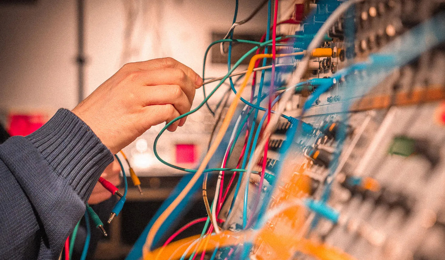 Hands patching modular synthesizer